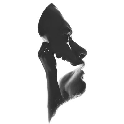 A double-exposure fine art portrait of taken from the same young thinking man, isolated on white background.